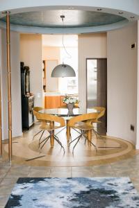 a dining room with a table and chairs at Apartment Blaumana 6 in Riga
