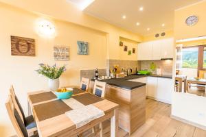a kitchen with a wooden table and a dining room at Apartament Sweet Home in Krynica Zdrój