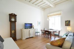 a living room with a couch and a table with a clock at Soderini Palace in Florence