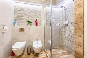 a bathroom with a toilet and a glass shower at Apartament Sweet Home in Krynica Zdrój +15 photos