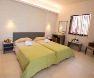 Postel nebo postele na pokoji v ubytování Astron Hotel