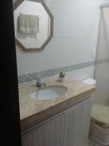 a bathroom with a sink and a mirror at Winterville Flats Gravatá in Gravatá