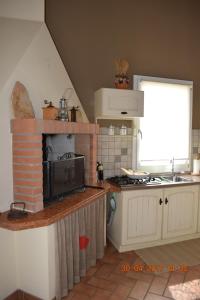 a kitchen with a stove and a stove top oven at Villa Posta Vecchia in Loreo