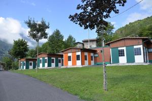 a row of houses on the side of a road at Camping Adamello in Edolo