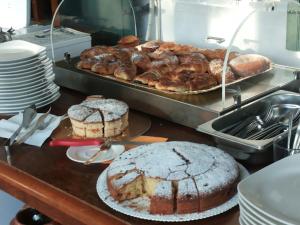 a kitchen with cakes and pastries on a counter at Breezes B&B in Conca Specchiulla
