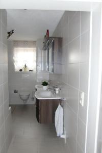 a bathroom with a sink and a toilet at Pension Irmisch in Aue