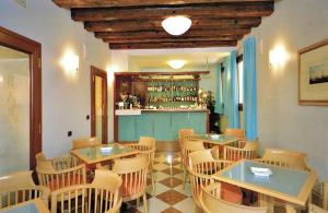 a restaurant with tables and chairs and a bar at Foscari Palace in Venice