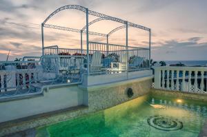 a house with a swimming pool and a balcony at Hotel Boutique Casa Córdoba Estrella in Cartagena de Indias