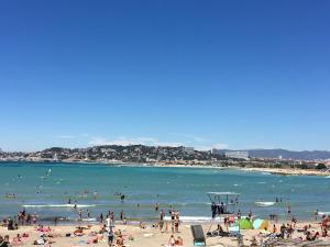 a group of people on a beach in the water at Quintessens in Marseille