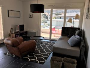 a living room with a couch and a chair at Quintessens in Marseille