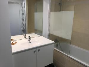 a white bathroom with a sink and a shower at Quintessens in Marseille