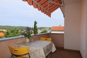 a table and chairs on a balcony with a view at Apartments Estee Soline in Soline