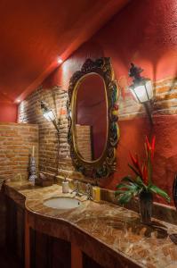 a bathroom with a sink and a mirror on the wall at Hotel Boutique Casa Córdoba Estrella in Cartagena de Indias
