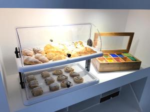 a display case filled with lots of donuts on a shelf at Porta Maqueda in Palermo