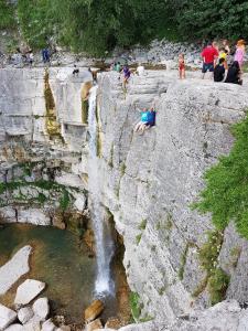 a group of people standing around a waterfall at Guesthouse Gua in Kutaisi