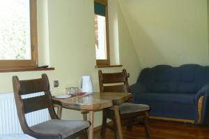 a living room with a table and a couch at Chatka Zuzia in Poronin