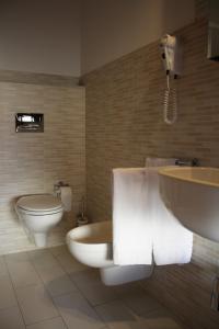 La salle de bains est pourvue de toilettes, d'un lavabo et d'une baignoire. dans l'établissement B&B 5 Sensi, à Belpasso