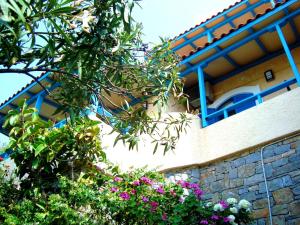 a building with flowers in front of it at Corina Apartments in Sitia