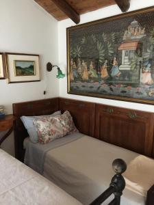 Farini dʼOlmoにあるOrto dei Sempliciのベッドルーム1室(ベッド2台付)が備わります。壁には絵画が飾られています。