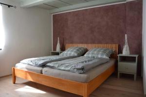 a bedroom with a large bed with a wooden headboard at Kunsthof Borsberg in Dresden