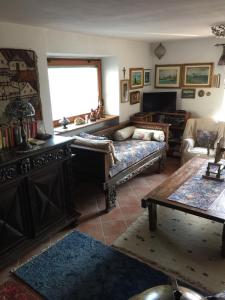 a living room with a couch and a piano at Orto dei Semplici in Farini dʼOlmo