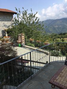 a balcony of a house with a view of the mountains at Orto dei Semplici in Farini dʼOlmo