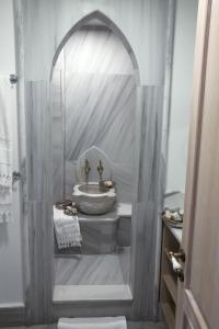 a bathroom with a shower with a sink and a toilet at Hotel Empress Zoe in Istanbul