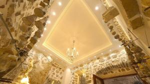 a room with a ceiling with a chandelier in it at Cattaro Royale Apartment in Kotor