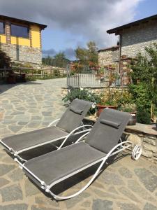 a pair of lounge chairs sitting on a patio at Orto dei Semplici in Farini dʼOlmo