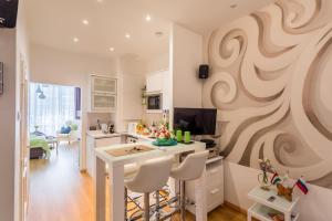 a kitchen with a wall with a swirl painted on it at Makes You Happy Budapest in Budapest
