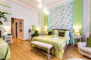 a hotel room with two beds and a couch at Makes You Happy Budapest in Budapest