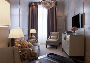 a living room with a couch and a tv at Grand Hôtel Stockholm in Stockholm