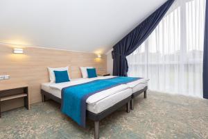 Łóżko lub łóżka w pokoju w obiekcie Hotel Vela