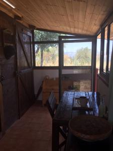 a dining room with a table and a large window at La Dolce Vita Country House with pool - Solicchiata in Castiglione di Sicilia