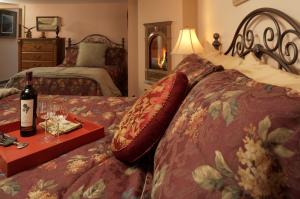 a bedroom with a bed with a bottle of wine and glasses at Black Bear Inn in Ketchikan