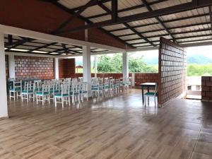 a room with tables and chairs in a building at Hotel Acuali Nuqui in Nuquí