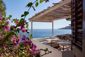 a view of the ocean from a house with flowers at Villa Tonnara in San Vito lo Capo
