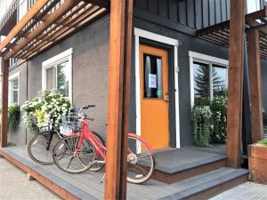 a red bike parked on the porch of a house at Snow Valley Lodging in Fernie