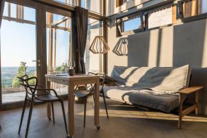 a bedroom with a bed and a desk and a table at WEINLOFTS Weinloft II in Eisenberg an der Pinka