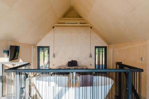 a room with a large tub in the center of a room at Weinloft II by WEINLOFTS in Eisenberg an der Pinka