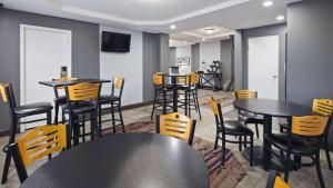 a dining room with tables, chairs, and tables at Best Western Inn at the Rochester Airport in Rochester