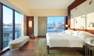 a hotel room with a bed and a balcony at Park Hyatt Zurich – City Center Luxury in Zurich