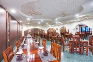 a dining room with wooden tables and chairs at Hotel Ranthambore Regency in Sawāi Mādhopur