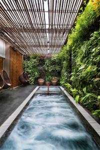 a pool of water in a room with plants at Alba Spa Hotel in Hue