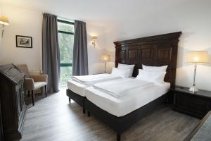 Postel nebo postele na pokoji v ubytování Höhen Hotel Viersen
