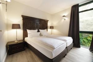 Postel nebo postele na pokoji v ubytování Höhen Hotel Viersen