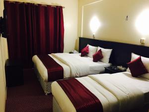 Postelja oz. postelje v sobi nastanitve Simba Hotel