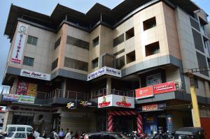 a building on a busy city street with cars at Hotel Citywalk Residency in Mangalore