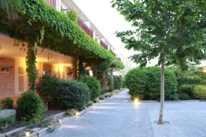 a courtyard of a building with trees and bushes at La Ermita in Brunete