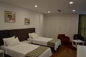 Rúm í herbergi á Havana Hotel